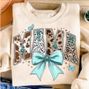 Coquette Western Mama Shirt with Cow Print, Turquoise & Bow Detail 1 small thumbnail