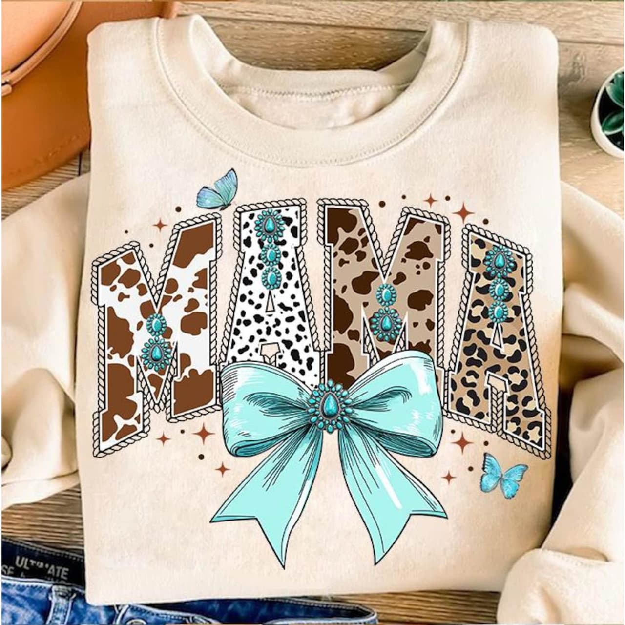 Coquette Western Mama Shirt with Cow Print, Turquoise & Bow Detail – image 1, Western Mama Tee, Western Mama Merch, Western Mama Shirt, Western Mama Sweatshirt, Western Mama Hoodie, Western Mama Clothes
